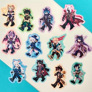 Puede incluir: Una colección de pegatinas coloridas con personajes de estilo anime con orejas de gato. Cada pegatina muestra un diseño de personaje único con atuendos y accesorios detallados. Las pegatinas están sobre un fondo blanco y turquesa.