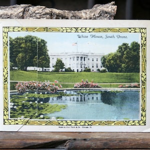 May include: A vintage postcard depicting the White House, South Front. The postcard shows a white building with a green lawn and a reflecting pool in the foreground. The text "White House, South Front" is printed at the top of the postcard.