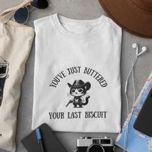 Funny Cat Biscuit Unisex T-Shirt | Softstyle Graphic Tee for Animal Lovers, Funny Cowboy Cat Tshirt, Meowdy Partner Sweatshirt