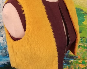 May include: A mustard yellow faux fur vest with a zipper closure. The vest is sleeveless and has a cropped length.