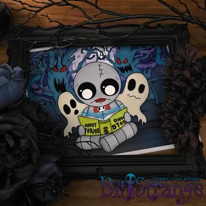 May include: A framed illustration featuring a gray cartoon doll reading a book titled "Ghost Stories" with two white ghosts. The background depicts a spooky forest scene with blue and purple hues. The frame is black, and the artwork has a Halloween theme.