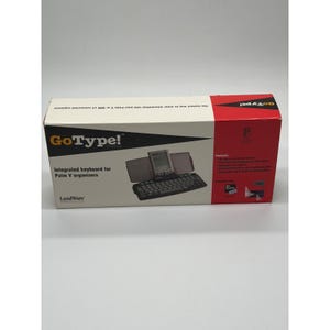 May include: A rectangular white and red cardboard box for a LandWare GoType! Pro integrated keyboard for Palm V organisers. The box features black text, a product illustration of the keyboard with a handheld device, and a list of features.