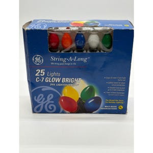 May include: A blue cardboard box containing 25 GE String-A-Long C-7 Glow Bright multi-colored holiday lights. The packaging displays the text 25 Lights C-7 GLOW BRIGHT and 24 ft. LIGHTED LENGTH, featuring images of red, yellow, green, and blue bulbs.