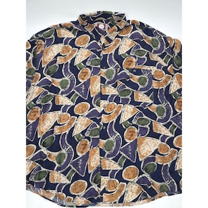 May include: Button-down shirt with a navy blue background and a repeating pattern of abstract shapes in shades of brown, purple, green, and tan. The shirt has a collared neckline and a single chest pocket.