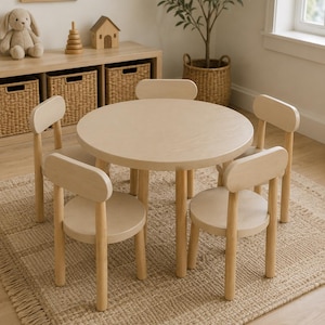 May include: A round light-colored wooden table with four matching chairs. The table features a smooth circular top supported by four cylindrical legs. Each chair has a curved backrest and a round seat, all constructed from light-toned wood.