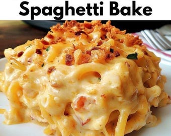 Puede incluir: Primer plano de una porción de Southern Chicken Spaghetti Bake en un plato blanco. El plato presenta espaguetis en una salsa cremosa y con queso, cubiertos con pan rallado. El texto "Southern Chicken Spaghetti Bake" es visible en la parte superior.