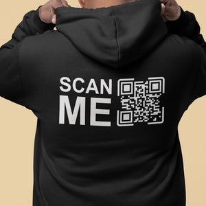 May include: Black zippered hoodie with the text "SCAN ME" and a QR code printed on the back.