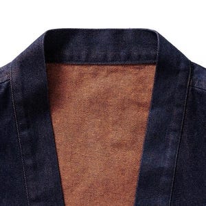 May include: A dark blue denim jacket with a brown lining. The jacket has a traditional Japanese style with a wide collar and a long, open front.