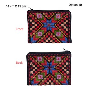 May include: A rectangular, black zippered pouch with a colorful cross-stitch design. The front and back of the pouch feature a geometric pattern in red, blue, green, and gold. The pouch measures 14 cm x 11 cm.