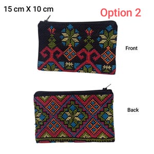 May include: Black rectangular zippered pouch, 15 cm x 10 cm, with colorful embroidered geometric patterns. The front and back designs are displayed. The front features a floral design with red, blue, green, and orange accents. The back has a diamond pattern.