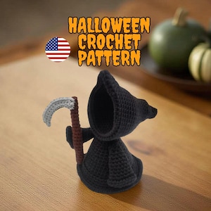 May include: A crocheted Halloween Grim Reaper figure in black, holding a gray scythe with a brown handle. The image includes text that reads "HALLOWEEN CROCHET PATTERN" and a circular American flag.