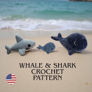 May include: Three crochet sea creatures: a gray shark, a small blue whale, and a larger blue whale. The text "WHALE & SHARK CROCHET PATTERN" is displayed below the creatures, along with an American flag.