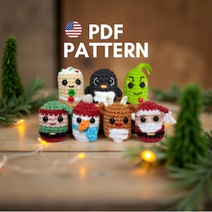 May include: A collection of seven crocheted Christmas-themed characters, including a snowman, penguin, and Santa Claus. The characters are in various colors and designs, with the text "PDF PATTERN" above them. The background is a blurred wooden surface with greenery.