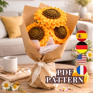 May include: A bouquet of three crocheted sunflowers with yellow petals and brown centers, wrapped in brown paper and tied with a white ribbon. The text "PDF PATTERN" is visible on the wrapping. The bouquet is on a wooden table.