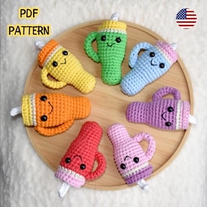 May include: A collection of colorful, crocheted drink-shaped toys, including yellow, orange, green, blue, pink, and purple. Each toy has a handle, a smiling face, and a white stick. The words "PDF PATTERN" are in the upper left corner.