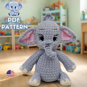 Peut inclure: Une peluche éléphant grise au crochet, faite à la main, avec l'intérieur des oreilles rose et de grands yeux noirs. L'éléphant a une trompe, des défenses et une petite couronne. L'image comprend le texte "PDF PATTERN" et un éléphant de dessin animé.