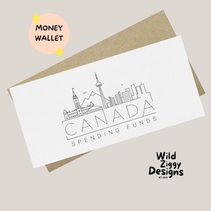 May include: A white money wallet featuring a black line drawing of the Canadian skyline, including the CN Tower, and the word "CANADA" with "SPENDING FUNDS" underneath. The words "MONEY WALLET" are in a pink circle.