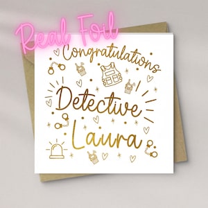 May include: A square white greeting card with gold foil text that reads Congratulations Detective Laura. The design features gold foil illustrations of handcuffs, walkie-talkies, a tactical vest, a siren, hearts, and stars, placed on a brown envelope.