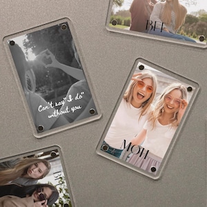 May include: Clear acrylic photo frames with images of people. Some frames have text that reads "Can't say I do without you", "BFF", "MOH", and "Bridesmaid". The photos are in color and black and white.