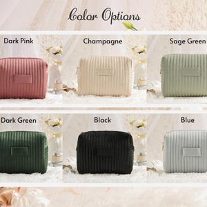 May include: Cosmetic bags in six colors: dark pink, champagne, sage green, dark green, black, and blue. Each bag has a rectangular shape with a ribbed texture and a small rectangular patch. The bags are displayed on a white surface.