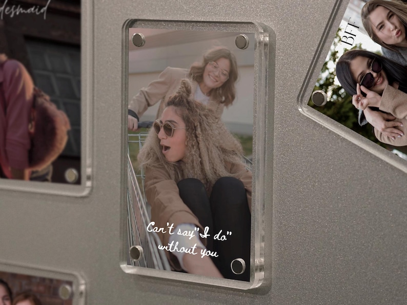 May include: Clear acrylic photo frame with a picture of two women, one in sunglasses and the other pushing a shopping cart. Text reads "Can't say "I do" without you."