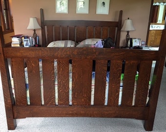 May include: A dark wood bed frame with a slatted headboard and footboard. The bed frame has a simple, traditional design.