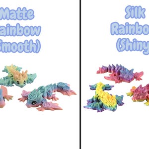 May include: Articulated rainbow dragons are displayed, with matte and silk finishes. Text above reads "Matte Rainbow (Smooth)" and "Silk Rainbow (Shiny)". The dragons are in different poses and feature a gradient of colours.