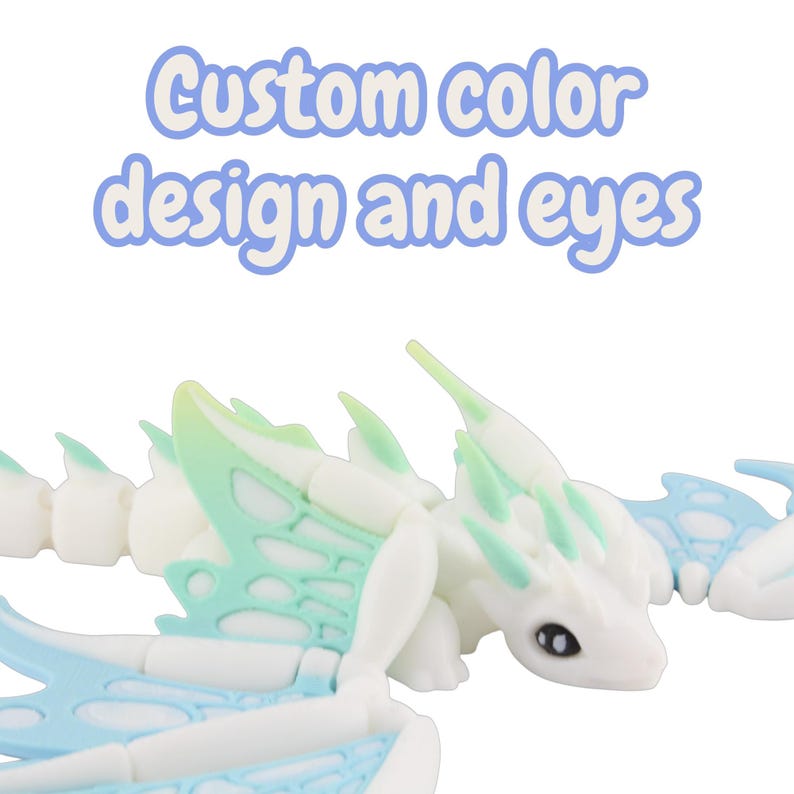 May include: A white articulated dragon toy with light blue and green accents. The text "Custom color design and eyes" is displayed above the dragon. The dragon has a detailed design with wings and a long tail.