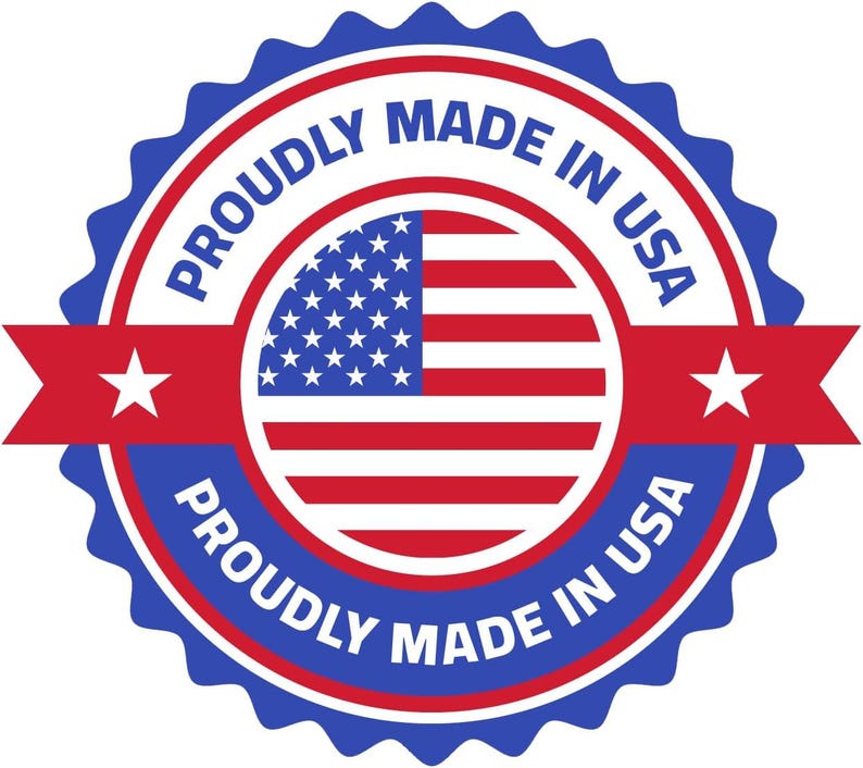 May include: A circular emblem with a blue scalloped border, red and white inner rings, and a central American flag design. The words "PROUDLY MADE IN USA" are written in white text around the emblem, with two red banners featuring white stars.