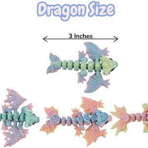 May include: A selection of articulated dragon toys in pastel colours. The text "Dragon Size" is above the top dragon, with a measurement of 7.6 cm. The dragons are shades of blue, pink, and yellow, with detailed wing and body designs.