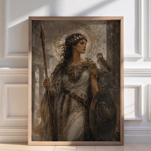 May include: A framed print of a classical painting depicting a woman in a white and gold gown, holding a spear and shield. An owl perches on her shoulder. The artwork has a golden halo and is set in a wooden frame.