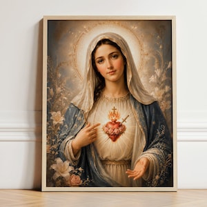 May include: A framed wall art print depicting a figure with a veil, wearing a blue and white robe, pointing toward a glowing, rose-adorned heart with a cross and sword. The background features soft light, a halo, and floral elements in muted tones.