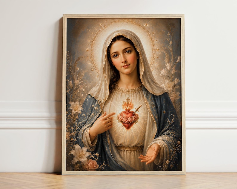 May include: A framed wall art print depicting a figure with a veil, wearing a blue and white robe, pointing toward a glowing, rose-adorned heart with a cross and sword. The background features soft light, a halo, and floral elements in muted tones.