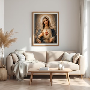 May include: A framed wall art print depicting a figure with a veil and a blue cloak, featuring a glowing heart with a sword and cross at the center. The artwork is rendered in soft, warm tones with a halo effect and floral accents in the background.