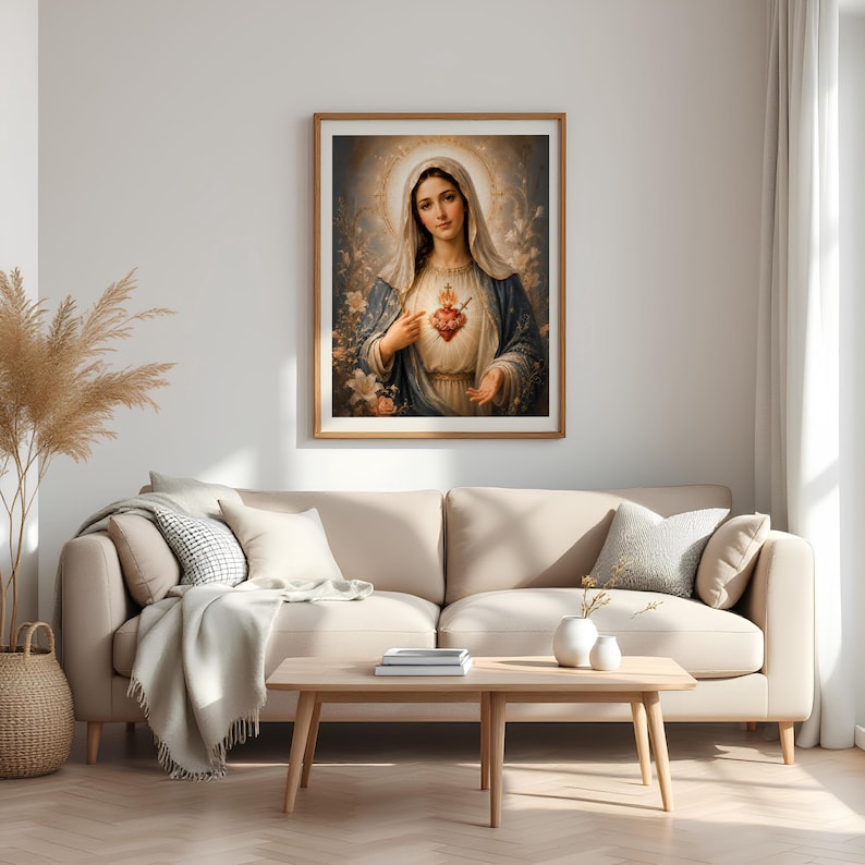May include: A framed wall art print depicting a figure with a veil and a blue cloak, featuring a glowing heart with a sword and cross at the center. The artwork is rendered in soft, warm tones with a halo effect and floral accents in the background.
