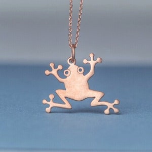 May include: A rose gold frog pendant necklace. The frog is a simple silhouette with no details.
