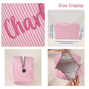 May include: A pink and white striped zippered pouch with pink embroidered script text. The pouch measures 8.5 inches in width, 6 inches in height, and 4 inches in depth. It features a silver-toned metal zipper pull and a white interior lining.