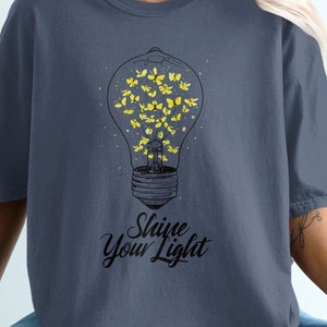 Shine Your Light T-Shirt, Inspirational Light Bulb Design, Motivational Quote Tee, Unique Graphic Shirt, Artistic Firefly Print