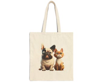May include: Cream-colored tote bag featuring a cartoon illustration of a dog and a cat. The dog is a French Bulldog with black and white markings and glasses. The cat is orange with brown stripes. The bag has two handles.