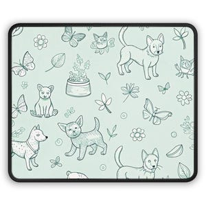 May include: A rectangular mousepad with a light green background and a black border. The surface features a repeating pattern of line art illustrations of dogs, butterflies, flowers, and leaves.