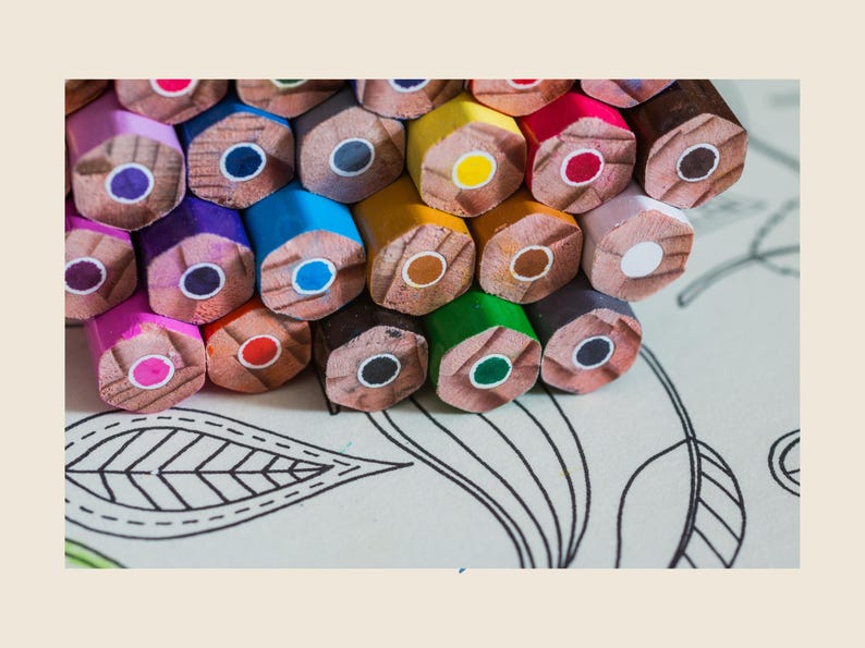May include: A close-up of a pile of colored pencils, arranged in a circular pattern. The pencils are all different colors, including red, blue, green, yellow, and orange. The pencils are on a white surface with a black and white pattern.