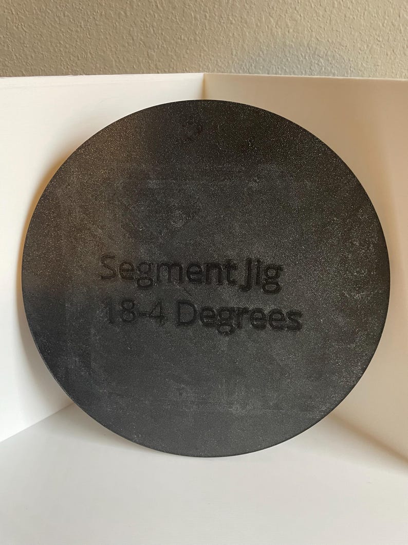May include: A black circular jig with the text "Segment Jig 18-4 Degrees" printed on it.