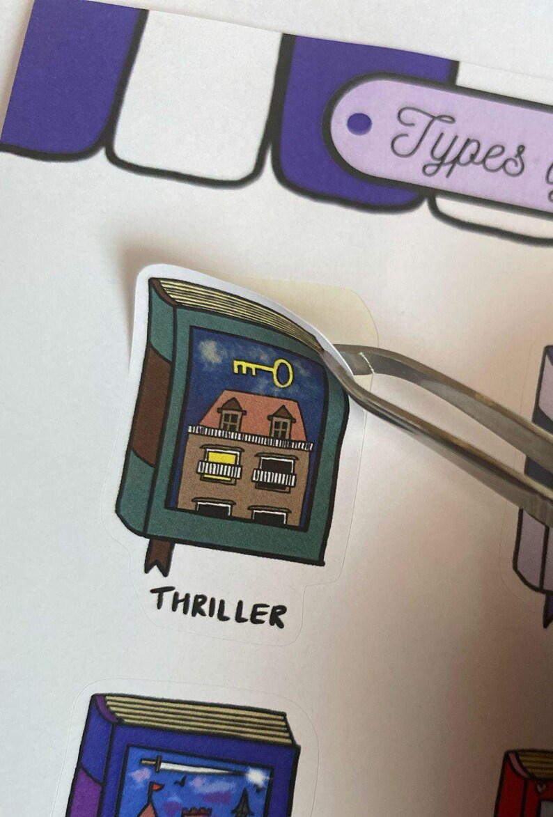 Thriller Book Sticker being peeled with a tweezer from the sticker sheet.