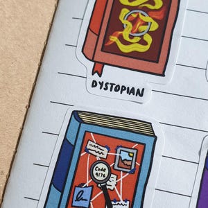 Dystopian and Mystery Book stickers on a lined notebook page.