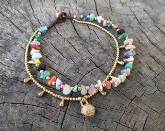 May include: A gold anklet with a charm and a double row of colourful gemstone beads.