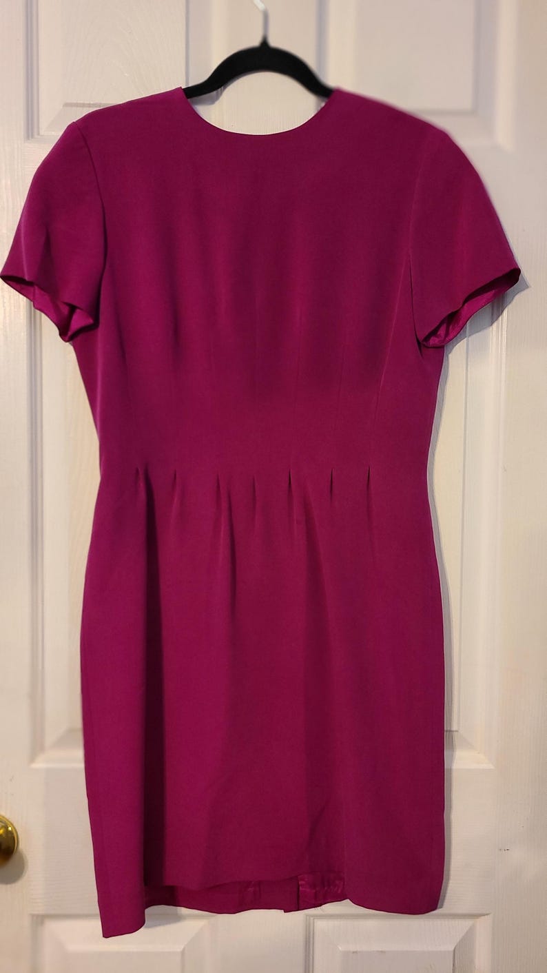Peut inclure: Une robe magenta &agrave; manches courtes avec un corsage ajust&eacute; et une jupe l&eacute;g&egrave;rement &eacute;vas&eacute;e.
