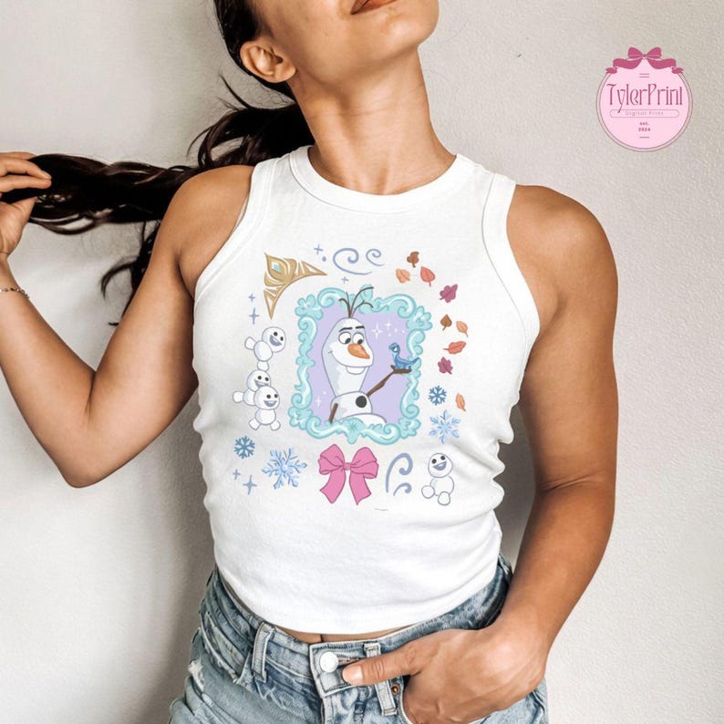 May include: White tank top featuring a cartoon image of Olaf from Frozen, framed with a light blue border. The design includes snowflakes, a pink bow, and the text "TylerPrint" in a pink circle.