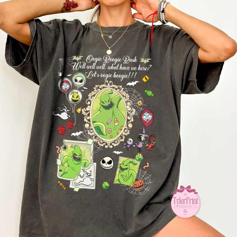 May include: Dark gray t-shirt featuring a green Oogie Boogie design with the text "Oogie Boogie Dash" and "Well well well, what have we here? Let's oogie boogie!!!" surrounded by Halloween-themed graphics.