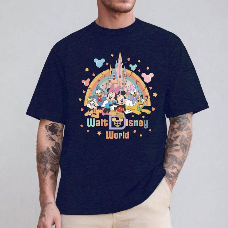 May include: A navy blue t-shirt with a colorful graphic of Mickey Mouse and friends in front of Cinderella's Castle. The graphic also includes a rainbow and the text "Walt Disney World".