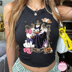 May include: Black tank top with a framed graphic of Daisy Duck and Maleficent. The design includes bats, a pumpkin, and a skull. The top is sleeveless and has a round neckline.